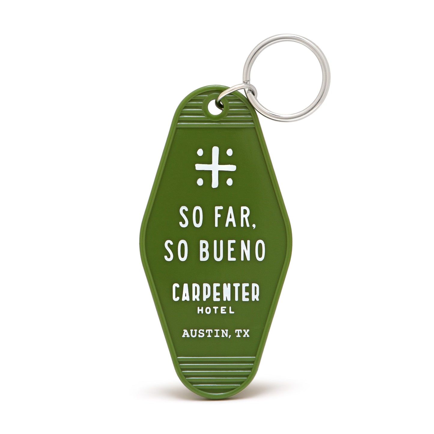 A green vintage-style keychain with white text that reads 'SO FAR, SO BUENO CARPENTER HOTEL AUSTIN, TX'.