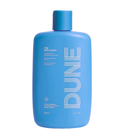 A blue bottle of sunscreen lotion labeled 'DUNE THE BOD GUARD' with text indicating SPF 30 and other product details.