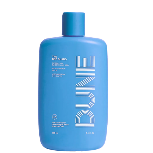 A blue bottle of sunscreen lotion labeled 'DUNE THE BOD GUARD' with text indicating SPF 30 and other product details.