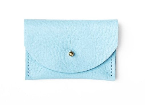 Pebbled leather robin blue cardholder with golden colored brass hardware against white background