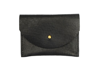 Black leather cardholder with golden colored brass hardware against white background
