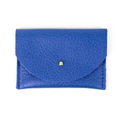 Pebbled leather lapis blue cardholder with golden colored brass hardware against white background