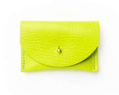 Neon lime leather wallet with a gold clasp on a white background