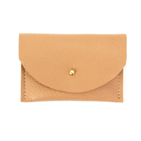 Tan leather cardholder with golden colored brass clasp on a white background
