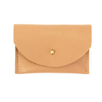 Tan leather cardholder with golden colored brass clasp on a white background