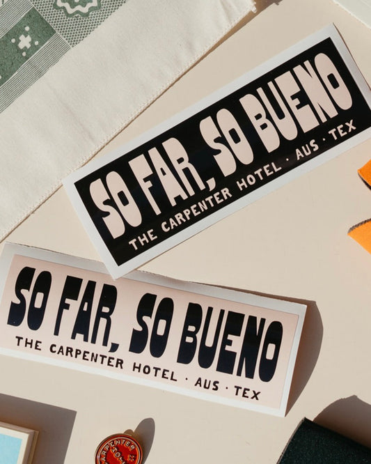 Stickers with the text 'SO FAR, SO BUENO THE CARPENTER HOTEL AUST TEX' printed on it in contrasting beige and black graphic, displayed on a neutral background.